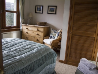 double bedroom finished with cushions and hanging photos
