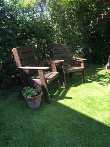 wooden garden chairs for guests to enjoy the Skye sunshine